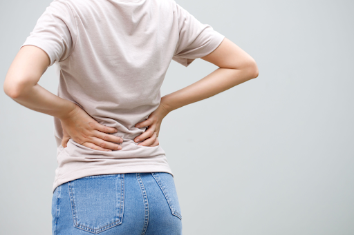 Woman clutching her lower back in pain