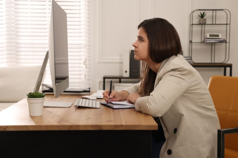 a woman with bad posture working at her desk